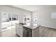 Bright kitchen with granite island, stainless steel appliances, and sliding glass door access at 119 Central Townes Way # 301, Raleigh, NC 27603