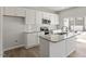 Bright kitchen with white cabinets, gray countertop island, and stainless steel appliances at 119 Central Townes Way # 301, Raleigh, NC 27603