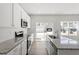 Open kitchen with white cabinets, stainless steel appliances, and gray countertops at 119 Central Townes Way # 301, Raleigh, NC 27603