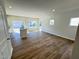 Open-concept living room with hardwood floors, recessed lighting, and sliding glass doors to the backyard at 119 Central Townes Way # 301, Raleigh, NC 27603
