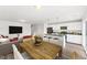Open floor plan with kitchen island, dining table, and living room featuring modern decor at 119 Central Townes Way # 301, Raleigh, NC 27603