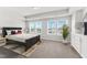Bedroom featuring natural light, a tray ceiling, and contemporary furnishings at 119 Central Townes Way # 301, Raleigh, NC 27603