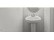 Compact powder room featuring a white pedestal sink and a modern faucet at 119 Central Townes Way # 301, Raleigh, NC 27603