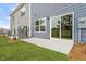Home exterior features a patio with sliding glass doors and a well-maintained lawn at 120 Fideaux Blvd # 257, Raleigh, NC 27603