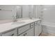 Bathroom with double sink vanity, white cabinets and a large mirror at 120 Fideaux Blvd # 257, Raleigh, NC 27603
