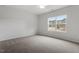 Neutral bedroom offers a ceiling fan and a large window for ample natural light at 120 Fideaux Blvd # 257, Raleigh, NC 27603