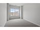 Bright bedroom featuring plush neutral carpeting and a large window at 120 Fideaux Blvd # 257, Raleigh, NC 27603