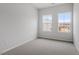 Bright bedroom with plush neutral carpeting and two large windows at 120 Fideaux Blvd # 257, Raleigh, NC 27603