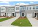 View of attractive townhomes showcasing modern design, individual garages, and manicured lawns at 120 Fideaux Blvd # 257, Raleigh, NC 27603