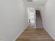 Bright foyer features hardwood floors, stairs to the second floor, and neutral paint at 120 Fideaux Blvd # 257, Raleigh, NC 27603