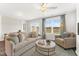Bright living room with neutral decor, ceiling fan, and large windows at 120 Fideaux Blvd # 257, Raleigh, NC 27603