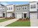 Charming townhomes featuring attached garages, tidy lawns, and welcoming front entries at 124 Fideaux Blvd # 256, Raleigh, NC 27603