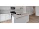 A modern kitchen boasts stainless steel appliances, granite counters, and a central island at 124 Fideaux Blvd # 256, Raleigh, NC 27603