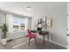 A virtual staged bedroom featuring a desk and chair by a window with natural light at 128 Fideaux Blvd # 255, Raleigh, NC 27603