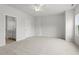 Bright bedroom featuring plush carpet and a ceiling fan, with an ensuite bathroom and walk-in closet at 128 Fideaux Blvd # 255, Raleigh, NC 27603