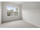 Bright bedroom with plush carpet, a window offering outside views, and electrical outlets at 128 Fideaux Blvd # 255, Raleigh, NC 27603