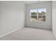 Bedroom featuring carpet flooring, a window with outside views, and electrical outlets at 128 Fideaux Blvd # 255, Raleigh, NC 27603