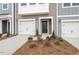 The townhome with welcoming front door is complemented by a manicured landscape at 128 Fideaux Blvd # 255, Raleigh, NC 27603