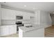 Bright kitchen featuring white cabinets, granite countertops, and modern stainless steel appliances at 128 Fideaux Blvd # 255, Raleigh, NC 27603