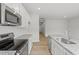 A well-equipped kitchen with granite countertops, white cabinets, and stainless steel appliances at 128 Fideaux Blvd # 255, Raleigh, NC 27603