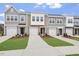 A row of townhomes, each with unique facade details and individual garages and landscaped lawns at 128 Fideaux Blvd # 255, Raleigh, NC 27603