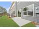 Backyard view with sliding glass doors to a concrete patio and green grass at 132 Fideaux Blvd # 254, Raleigh, NC 27603