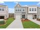 Charming townhomes with attached garages and well-maintained lawns create an inviting curb appeal at 132 Fideaux Blvd # 254, Raleigh, NC 27603