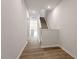 Bright hallway features hardwood floors and a staircase leading to the upper level at 132 Fideaux Blvd # 254, Raleigh, NC 27603