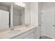 Bathroom with double sinks, white cabinetry, a large mirror and a tile shower and tub at 136 Fideaux Blvd # 253, Raleigh, NC 27603