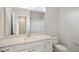 Bright bathroom featuring a single sink, white cabinetry, a large mirror and a toilet at 136 Fideaux Blvd # 253, Raleigh, NC 27603