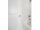 Close-up on bathroom with tiled shower and tub, and a white door at 136 Fideaux Blvd # 253, Raleigh, NC 27603