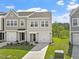 Charming townhome with gray siding, a one-car garage, and a well-manicured lawn and landscaping at 136 Fideaux Blvd # 253, Raleigh, NC 27603