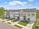 Wide shot showcasing the exteriors of newly constructed townhomes, each with driveways and lawns at 136 Fideaux Blvd # 253, Raleigh, NC 27603