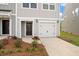 Up close exterior of townhome featuring a garage and walkway with fresh landscaping at 136 Fideaux Blvd # 253, Raleigh, NC 27603