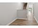 Hallway features wood floors and stairs, leading to an open space at the end of the hall at 136 Fideaux Blvd # 253, Raleigh, NC 27603