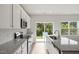 Bright kitchen features stainless appliances, granite countertops, and a garden view through sliding glass doors at 136 Fideaux Blvd # 253, Raleigh, NC 27603