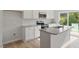 Bright kitchen with white cabinetry, granite countertops, stainless steel appliances, and a center island at 136 Fideaux Blvd # 253, Raleigh, NC 27603