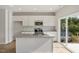 Kitchen with white cabinets, granite countertops, stainless steel appliances, and access to the backyard at 136 Fideaux Blvd # 253, Raleigh, NC 27603