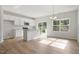 Kitchen and dining area features modern lighting, wood floors, white cabinets and stainless steel appliances at 136 Fideaux Blvd # 253, Raleigh, NC 27603