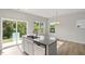Kitchen island boasts granite countertops and stainless steel dishwasher in this open floor plan with a patio view at 136 Fideaux Blvd # 253, Raleigh, NC 27603