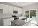 Kitchen features stainless steel appliances, granite countertops, and white cabinets at 136 Fideaux Blvd # 253, Raleigh, NC 27603