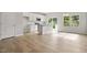 Open concept living area features wood floors and a kitchen with white cabinets and stainless steel appliances at 136 Fideaux Blvd # 253, Raleigh, NC 27603