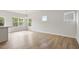 Bright, open-concept living area with wood floors and lots of natural light from multiple windows at 136 Fideaux Blvd # 253, Raleigh, NC 27603