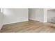 Spacious living area with wood floors, white trim, and a door leading to the next room at 136 Fideaux Blvd # 253, Raleigh, NC 27603