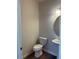 A powder bathroom featuring a toilet, sink, and a vanity with a round mirror at 142 Vega Loop, Sanford, NC 27330