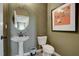 Powder room with pedestal sink and oval mirror at 142 Vega Loop, Sanford, NC 27330