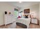 Spacious bedroom with a dresser, nightstands, and large window at 142 Vega Loop, Sanford, NC 27330