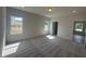 Large bedroom with cozy carpeting, two large windows, and natural light at 142 Vega Loop, Sanford, NC 27330