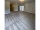 A large carpeted living room features neutral walls, and several entryways and doorways at 142 Vega Loop, Sanford, NC 27330