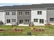 Aerial backyard view showing patios, landscaping and multi-tone townhouse exteriors at 144 Fideaux Blvd # 251, Raleigh, NC 27603